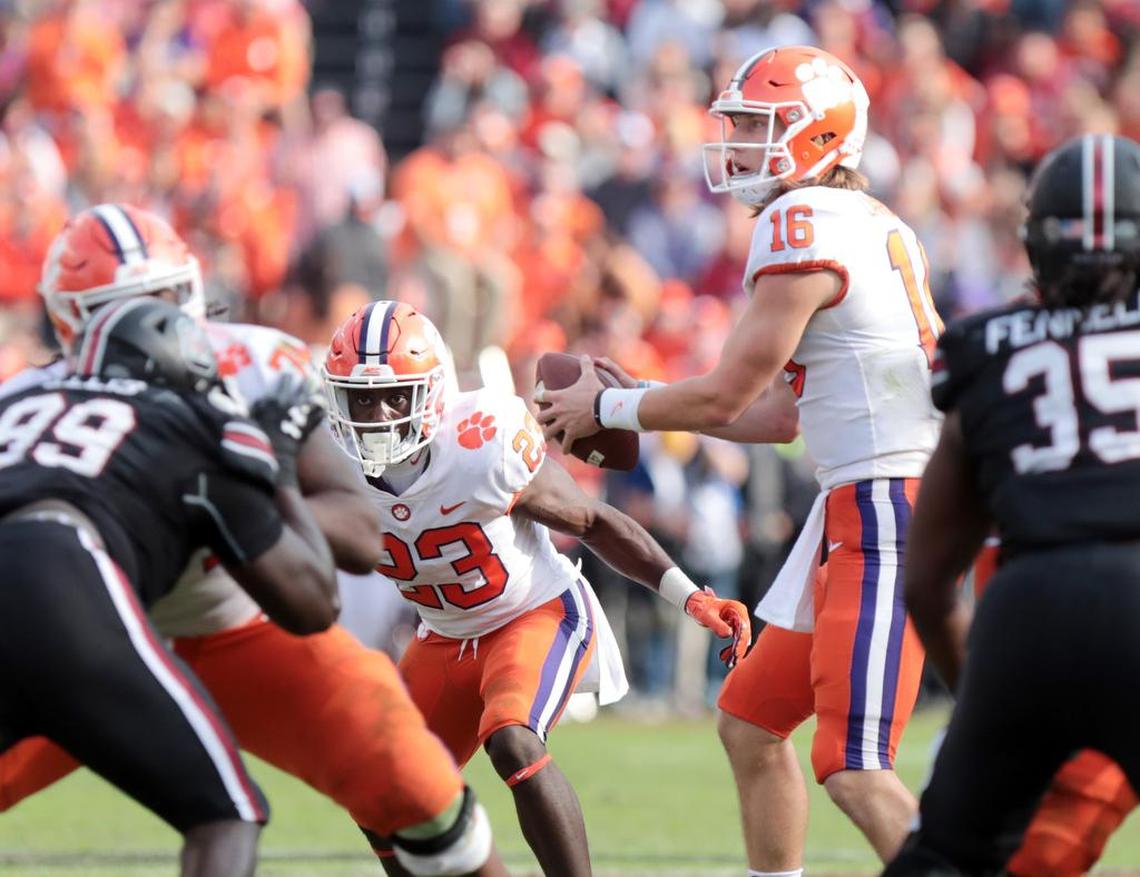 Clemson’s Trevor Lawrence looks for an opening Saturday as the South Carolina Gamecocks take on the Clemson Tigers in Columbia.
