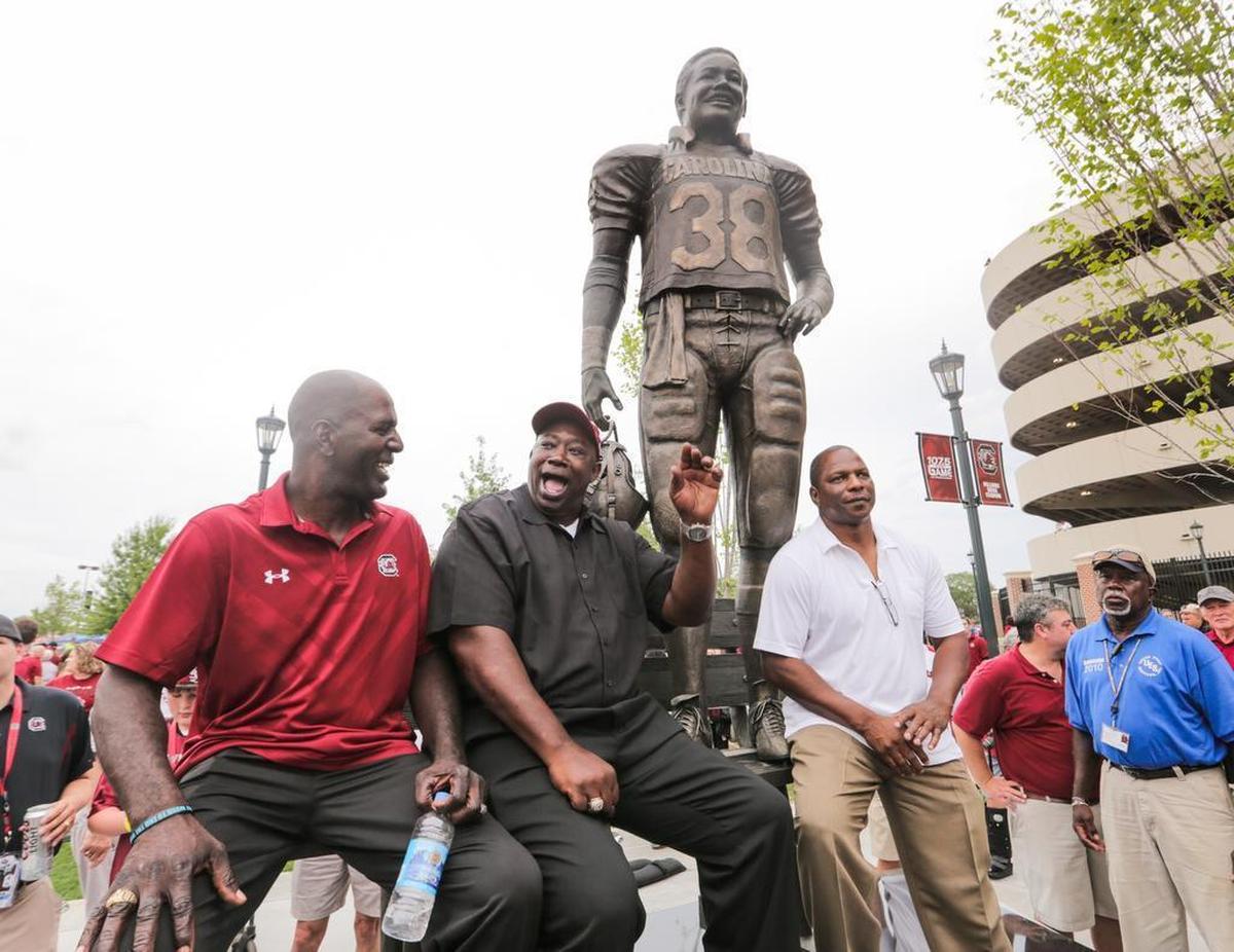 George Rogers poses with former teammates after his statue was unveiled in 2015