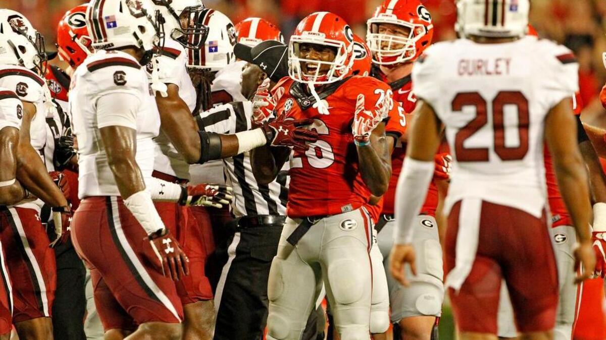 
Georgia Bulldogs wide receiver Malcolm Mitchell (26) has words for some Gamecock players in the second half at Sanford Stadium in Athens, Ga.
