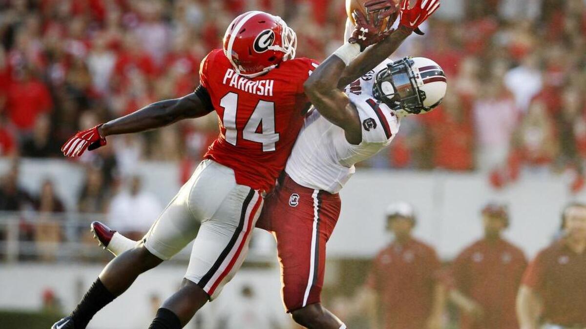 
Georgia Bulldogs cornerback Malkom Parrish (14) breaks up a pass intended for South Carolina Gamecocks wide receiver Deebo Samuel (1).

