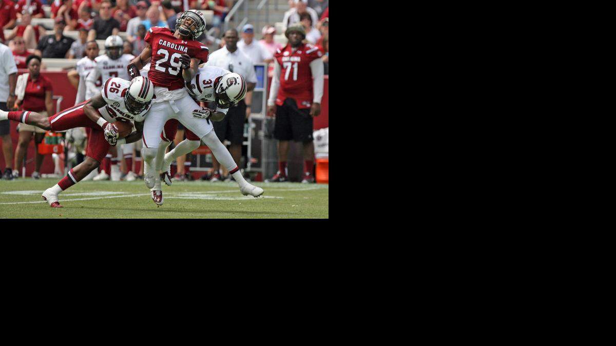 
Jasper Sasser (26) intercepts a pass intended for Matrick Belton (29) during the Garnet and Black Spring Game at Williams-Brice Stadium.
