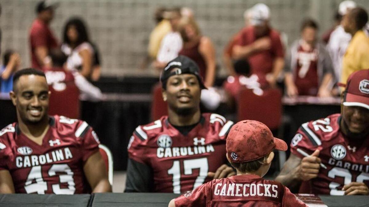 
Jack Coleman collects autographs from Benji Russell, Chaz Elder and Jamari Smith at the USC Fan Appreciation Day Sunday afternoon at the Columbia Metro Convention Center.
