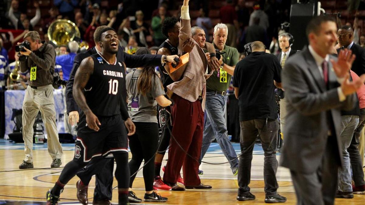 South Carolina Gamecocks guard Duane Notice (10) forward Chris Silva (30) and head coach Frank Martin celebrate their win over Duke at Bon Secours Wellness Arena.
