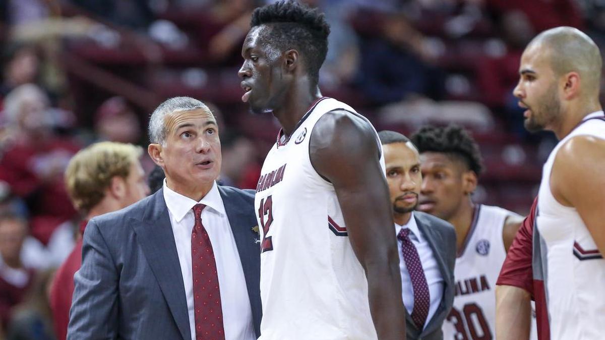 Coach Frank Martin talks with South Carolina's Khadim Gueye (12) during the second half of action in the Colonial Life Arena. USC won, 78-60.
