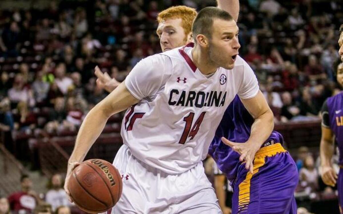 Laimonas Chatkevicius drives around Lipscomb center David Wishon in the first half.