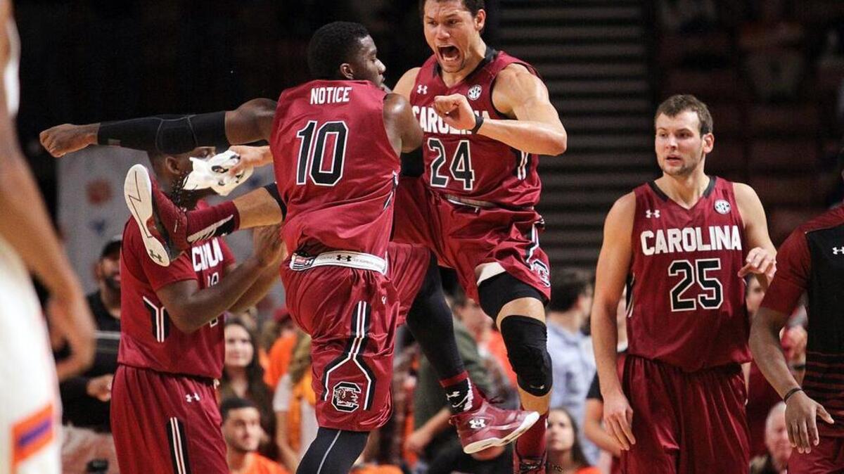 South Carolina guard Duane Notice (10) and forward Michael Carrera (24) celebrate during Friday night’s win over Clemson.
