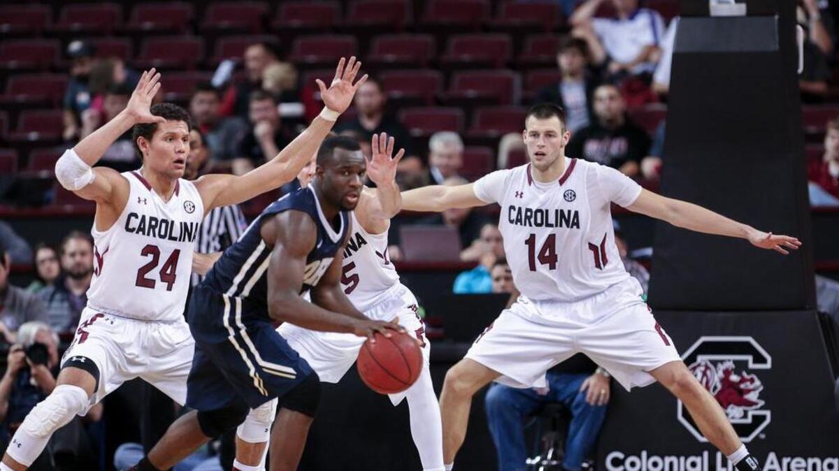 South Carolina's Michael Carrera (24), Mindaugas Kacinas (25) and Laimonas Chatkevicius (14)