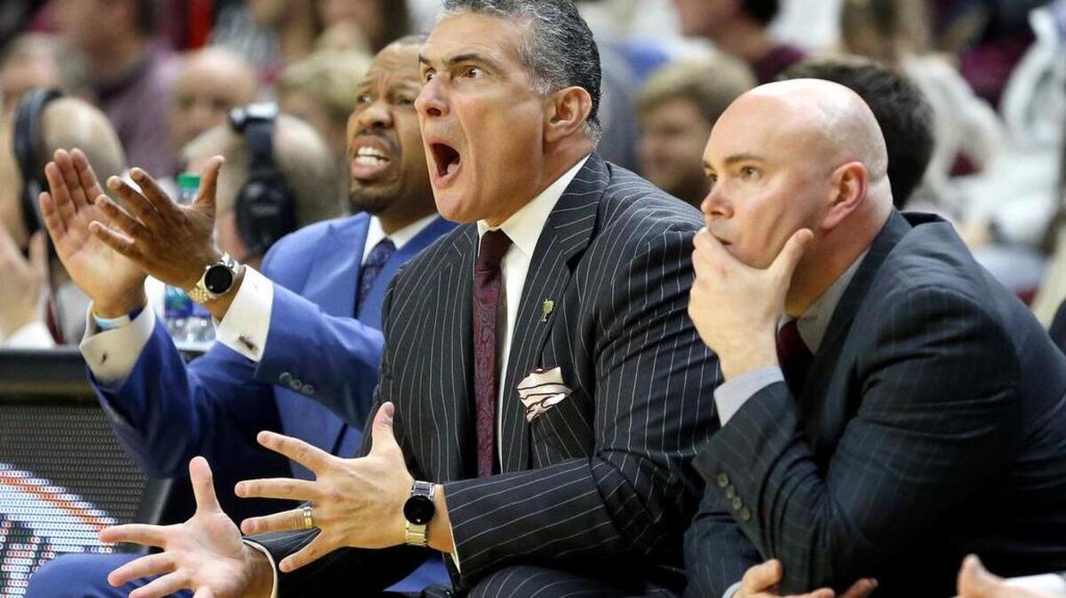 South Carolina head coach Frank Martin, center, reacts after a call during the first half of an NCAA college basketball game against Texas A&M on Saturday in College Station, Texas. USC won its 20th game this season.