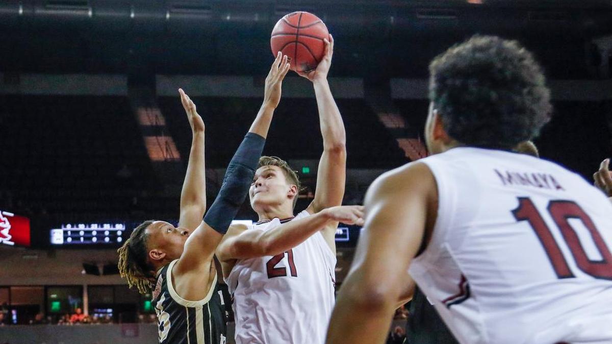 South Carolina's Maik Kotsar (21) shoots over Western Michigan's Brandon Johnson (35)