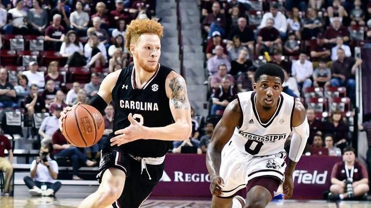 South Carolina Gamecocks guard Hassani Gravett (2) moves the ball down the court as he is defended by Mississippi State Bulldogs guard Nick Weatherspoon (0) during the game at Humphrey Coliseum.