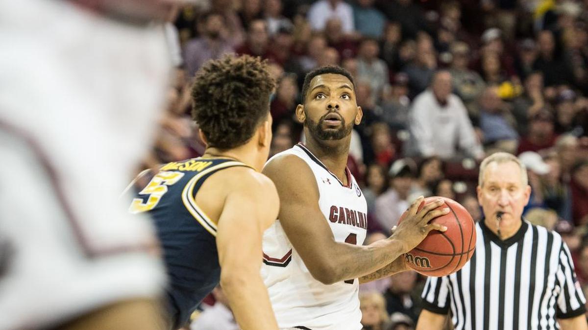 USC's Sindarius Thornwell (0) eyes the bucket while Michigan's D.J. Wilson defends during their game on Wednesday.