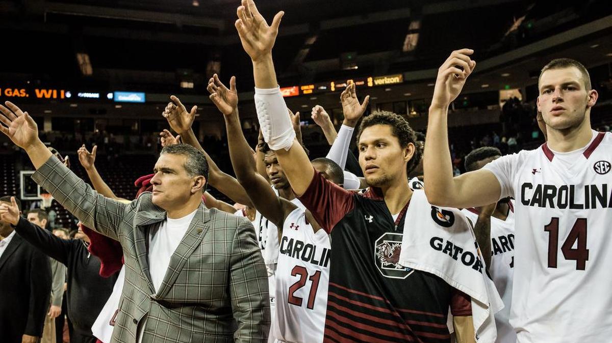 Gamecock coach Frank Martin, Michael Carrera, and Laimonas Chatkevicius during the alma mater following a win against Allen University in exhibition play Sunday afternoon at Colonial Life Arena. The Gamecocks will begin their season November 14 against Norfolk State.