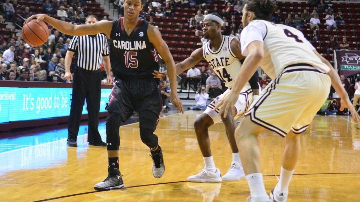 South Carolina Gamecocks guard PJ Dozier (15) is defended by Mississippi State guard Malik Newman (14) and forward Johnny Zuppardo (4) during the game at Humphrey Coliseum.