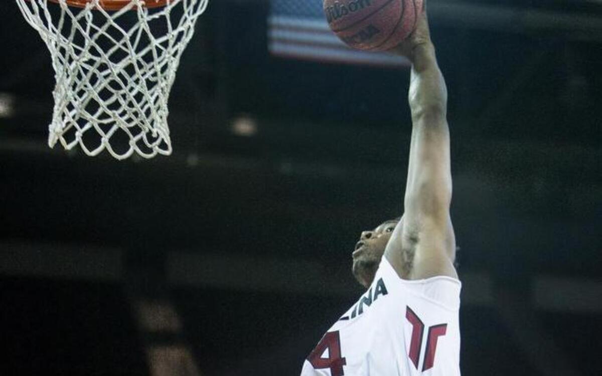 South Carolina's Jamall Gregory (4) dunks on Francis Marion's Mike Davis Jr. (3) during the first half of action in the Colonial Life Arena.