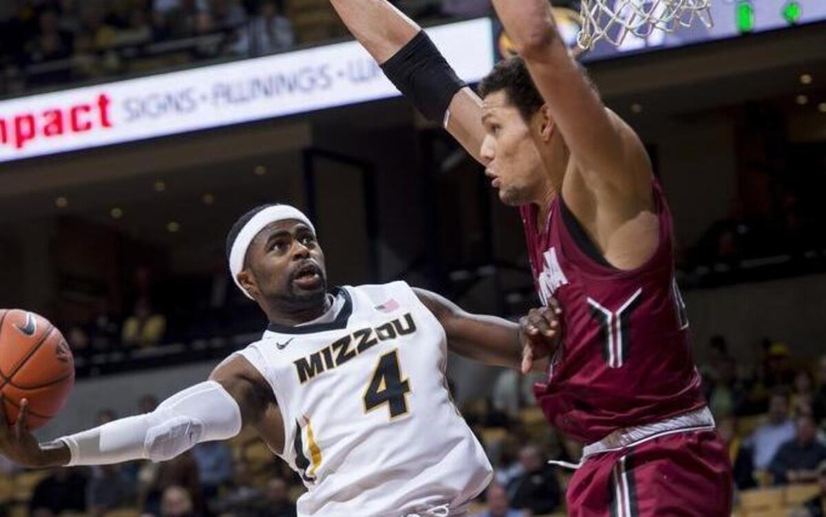 Missouri's Tramaine Isabell, left, shoots past South Carolina's Michael Carrera, right, during their game Tuesday night in Columbia, Mo.