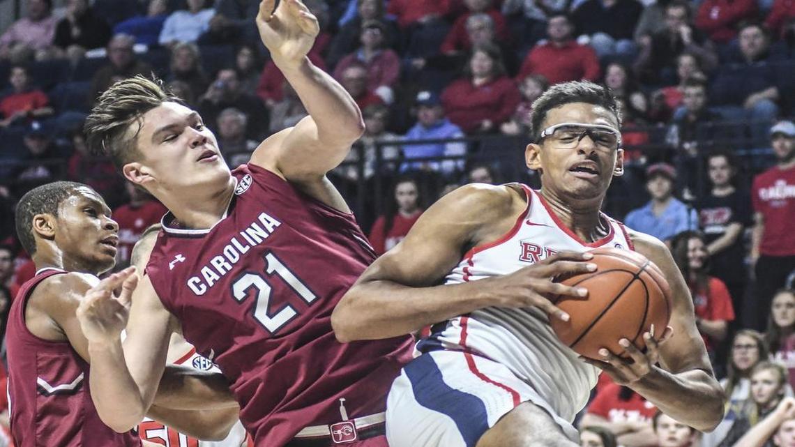 Ole Miss forward Sebastian Saiz grabs a rebound in front of South Carolina forward Maik Kotsar.