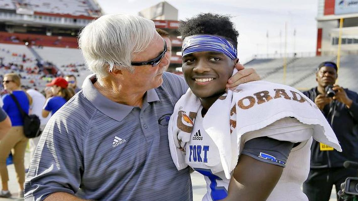 Fort Dorchester coach Steve LaPrad celebrates with quarterback Dakereon Joyner as the clock runs out on their victory over Dorman during their Class 4A Division 1 state championship win.