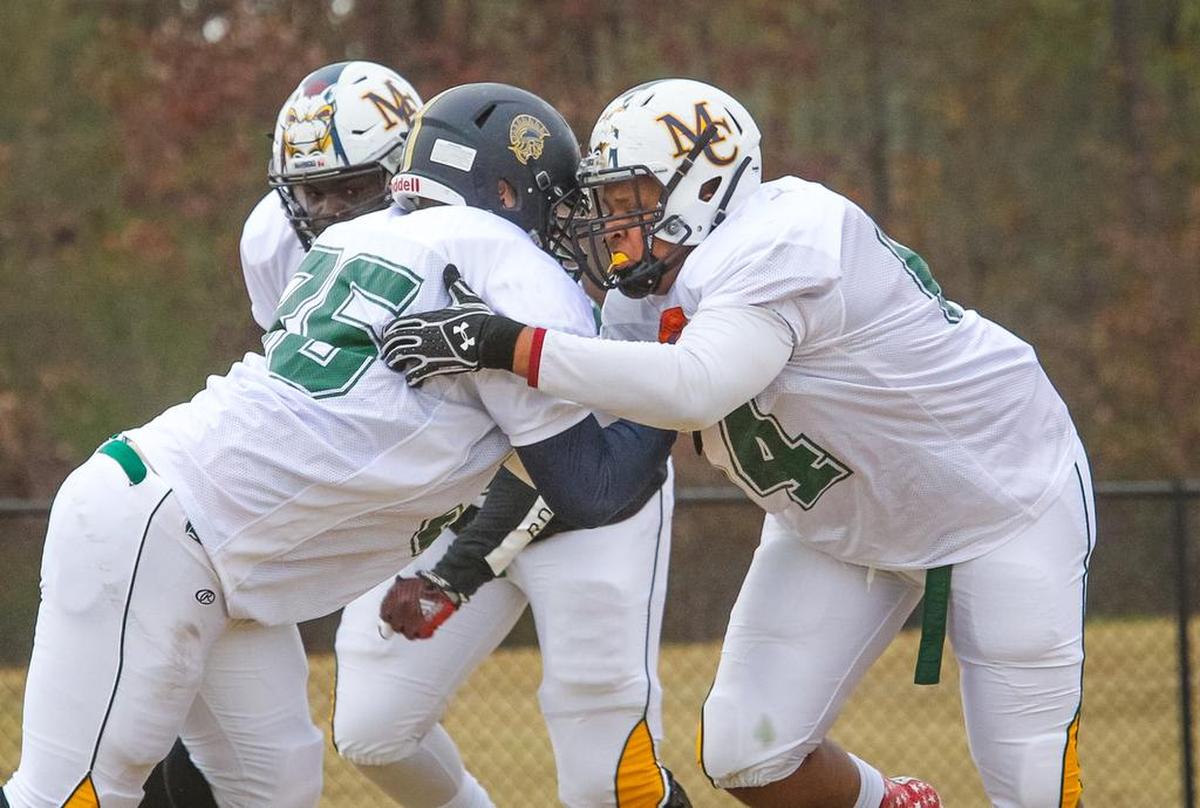 South Carolina offensive line commit Eric Douglas, right, at 2016 Shrine Bowl practice.