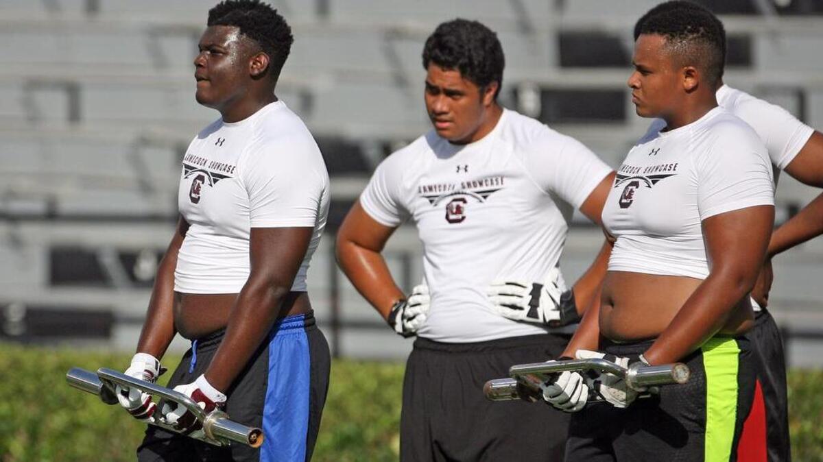 T.J. Moore, left, and Eric Douglas, right, at last year’s Gamecock Showcase camp.