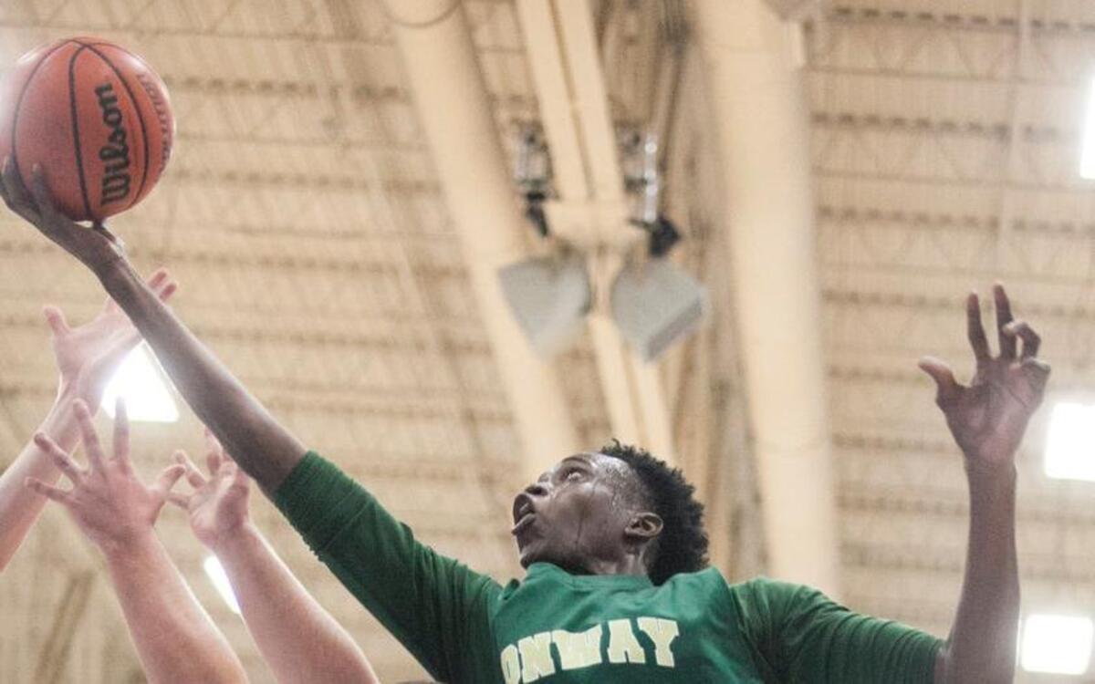 Conway's Jimmy Nichols gets a shot off under the net against St. James. St. James hosts Conway High in boys and girls basketball on Tuesday night.