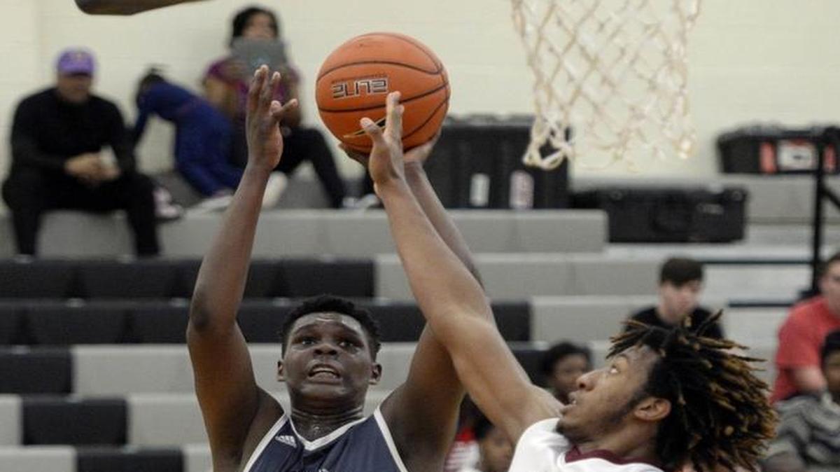 York Prep's DJ Burns (32) shoots over New Hampstead's Xavier Jones (23) during their game in the Charlotte Hoops Challenge.