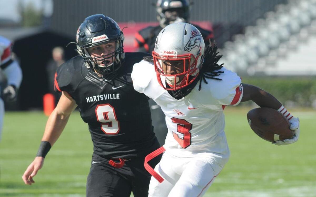 South Pointe's Steven Gilmore Jr. carries the ball as Hartsville's Logan Carpenter follows.