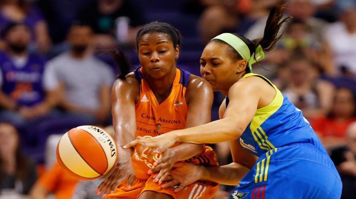 Phoenix Mercury forward Camille Little (20) and Dallas Wings guard Allisha Gray (15) battle for the ball Sunday in Phoenix.