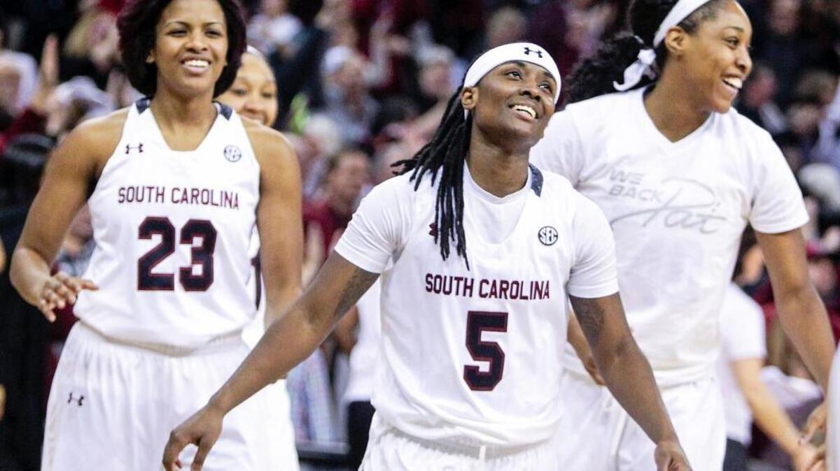 South Carolina's Khadijah Sessions (5) Tina Roy and Jatarie White celebrate after beating Texas A&M in the Colonial Life Arena. USC won, 59-58.