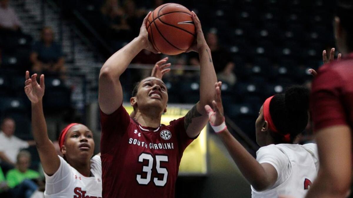 South Carolina's Alexis Jennings (35) shoots as St. John's Qadashah Hoppie (21) and Tiana England, right, defend during the second quarter of the Gulf Coast Showcase NCAA college basketball tournament, Saturday, Nov. 25, 2017, in Estero, Fla.