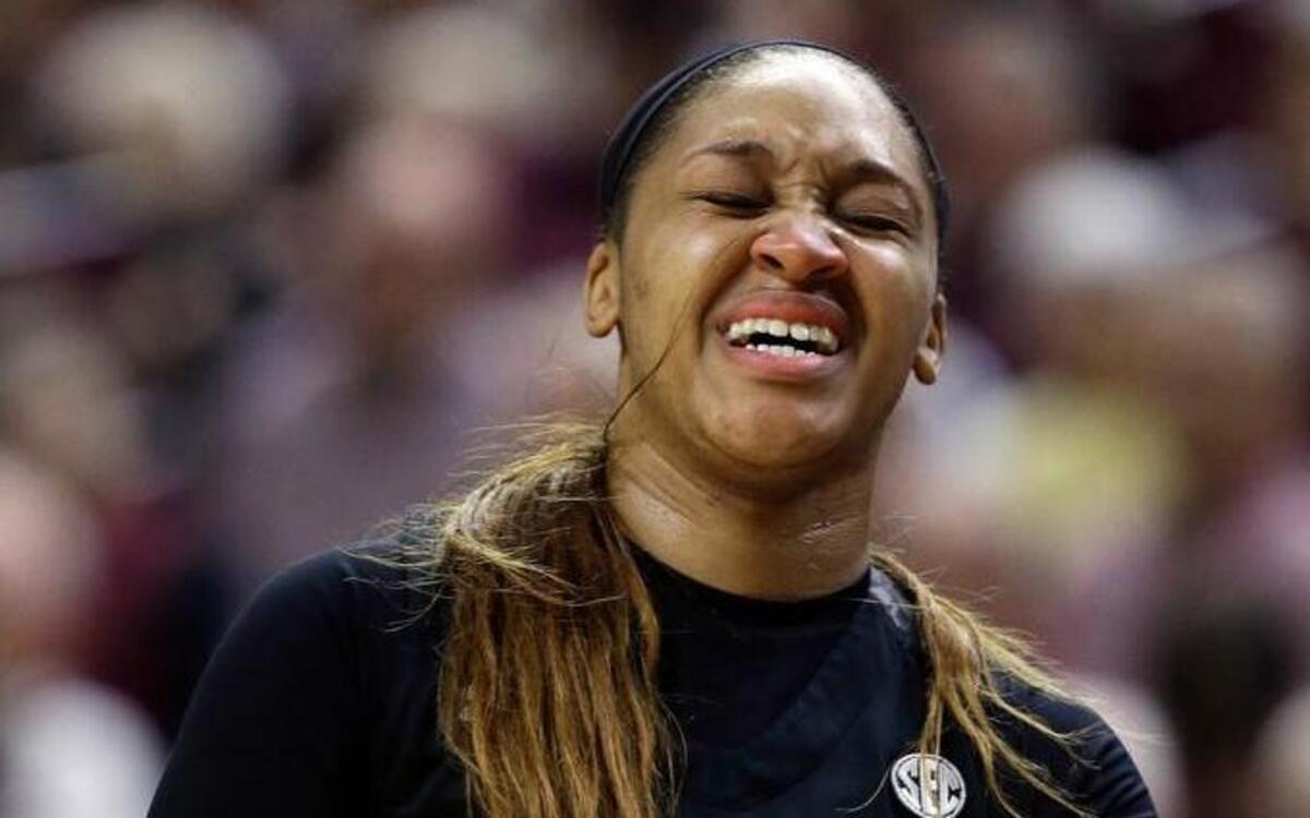 South Carolina's Asia Dozier holds her wrist as she leaves the court during the game against Texas A&M on Sunday.