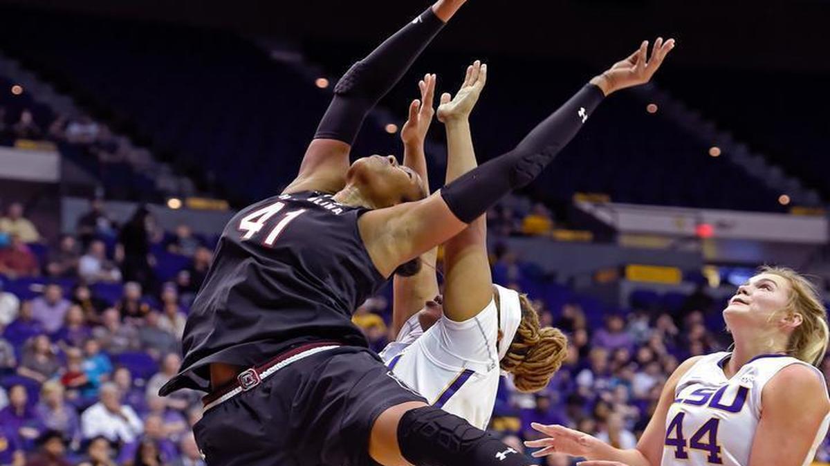 South Carolina center Alaina Coates puts the ball up as LSU forwards Alexis Hyder and Tatum Neubert (44) defend Sunday.
