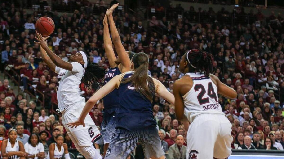South Carolina's Khadijah Sessions (5) shoots under Connecticut defenders