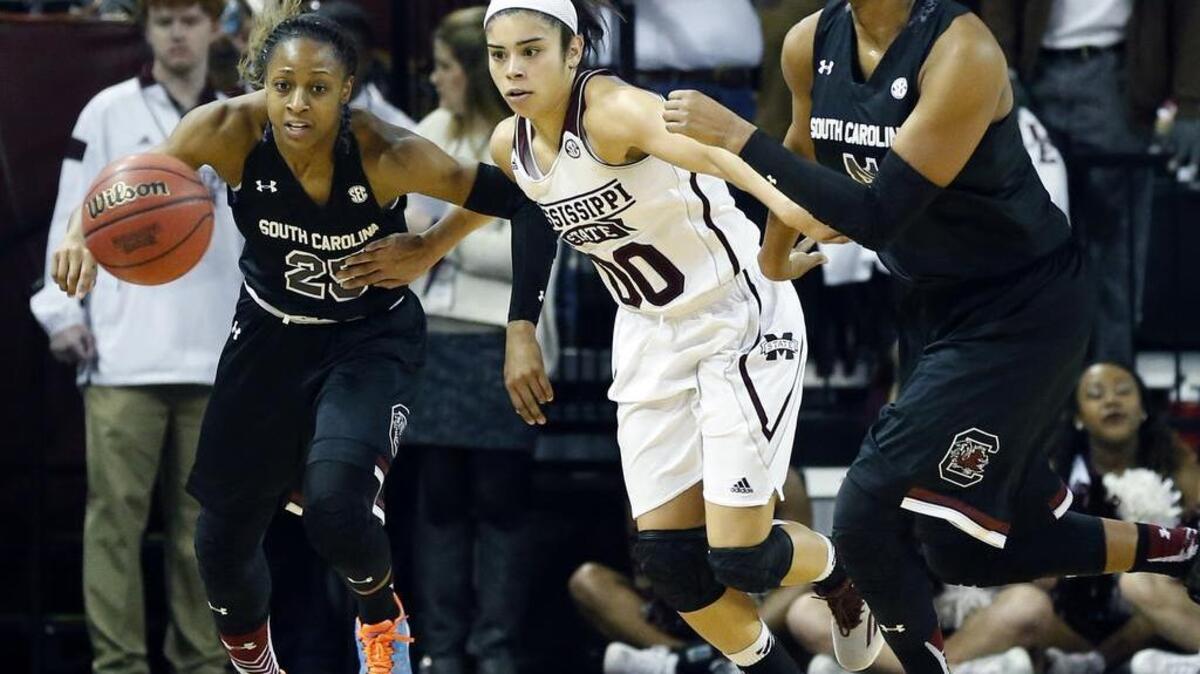 Mississippi State guard Dominique Dillingham (00) races South Carolina guard Tiffany Mitchell (25) and center Alaina Coates (41), right, for a loose ball in the first half of an NCAA college basketball game in Starkville, Miss., Sunday, Jan. 24, 2016. South Carolina won 57-51.