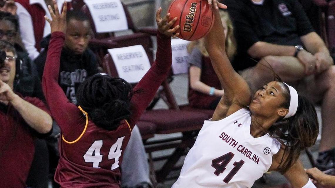 South Carolina's Alaina Coates (41) blocks a shot by Winthrop's Ezinne Mbamalu (44) during the first half Sunday.