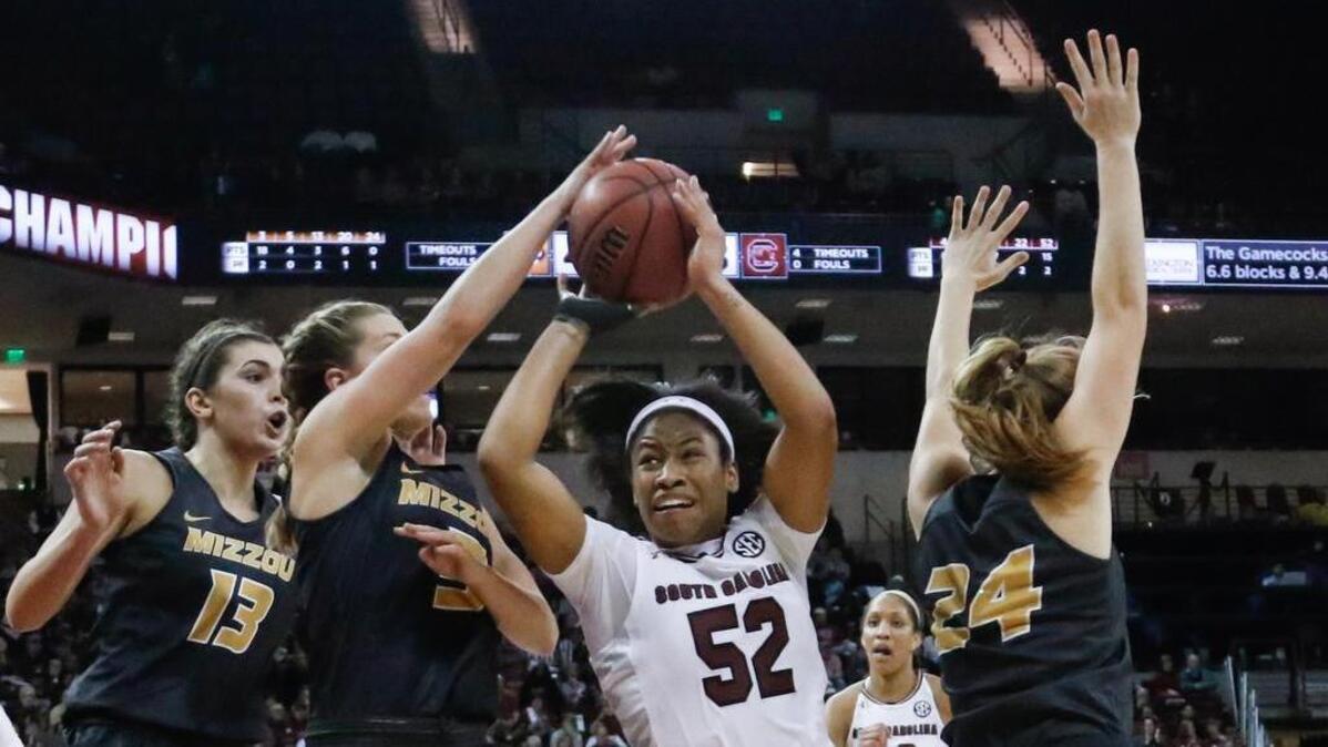 South Carolina's Tyasha Harris (52) drives through Missouri's Sophie Cunningham (3) and Missouri's Jordan Chavis (24) during the first half of action in the game on Jan. 28, 2018.