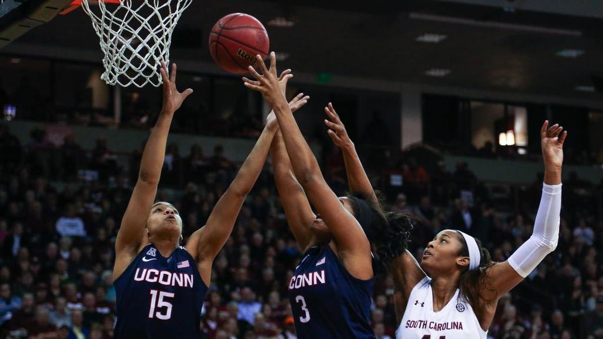 South Carolina's Alaina Coates (41) tries for a rebound as Connecticut's Gabby Williams (15) and Connecticut's Morgan Tuck (3) snag the ball during the second half of action in the Colonial Life Arena.