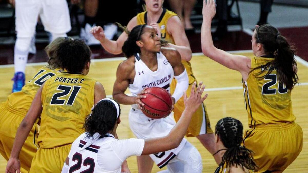 South Carolina's Tiffany Mitchell (25) shoots through a crowd of Missouri defenders including Missouri's Kayla McDowell (20) and Missouri's Cierra Porter (21) during their game at Colonial Life Arena.