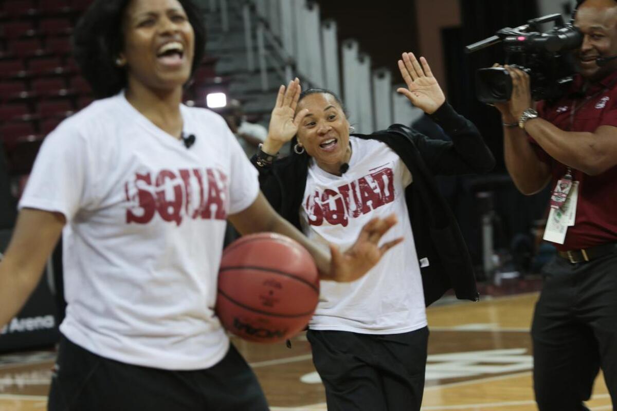 Gamecocks coach Dawn Staley celebrates along with Tiffany Mitchell and Tina Roy during an NCAA watch party at Colonial Life Arena. The Gamecocks were selected as the No. 1 seed in the Sioux Falls regional.