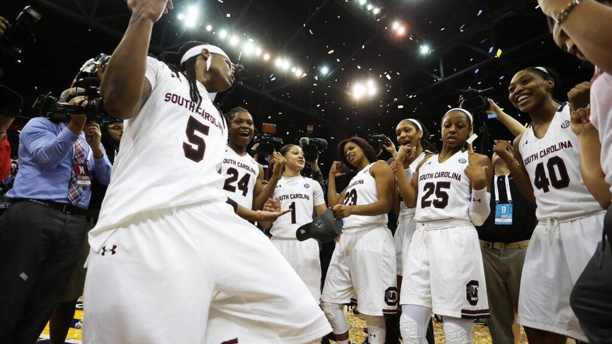 The South Carolina Gamecocks celebrate after beating the Mississippi State Lady Bulldogs to win the women's SEC basketball tournament at Jacksonville Memorial Veterans Arena.