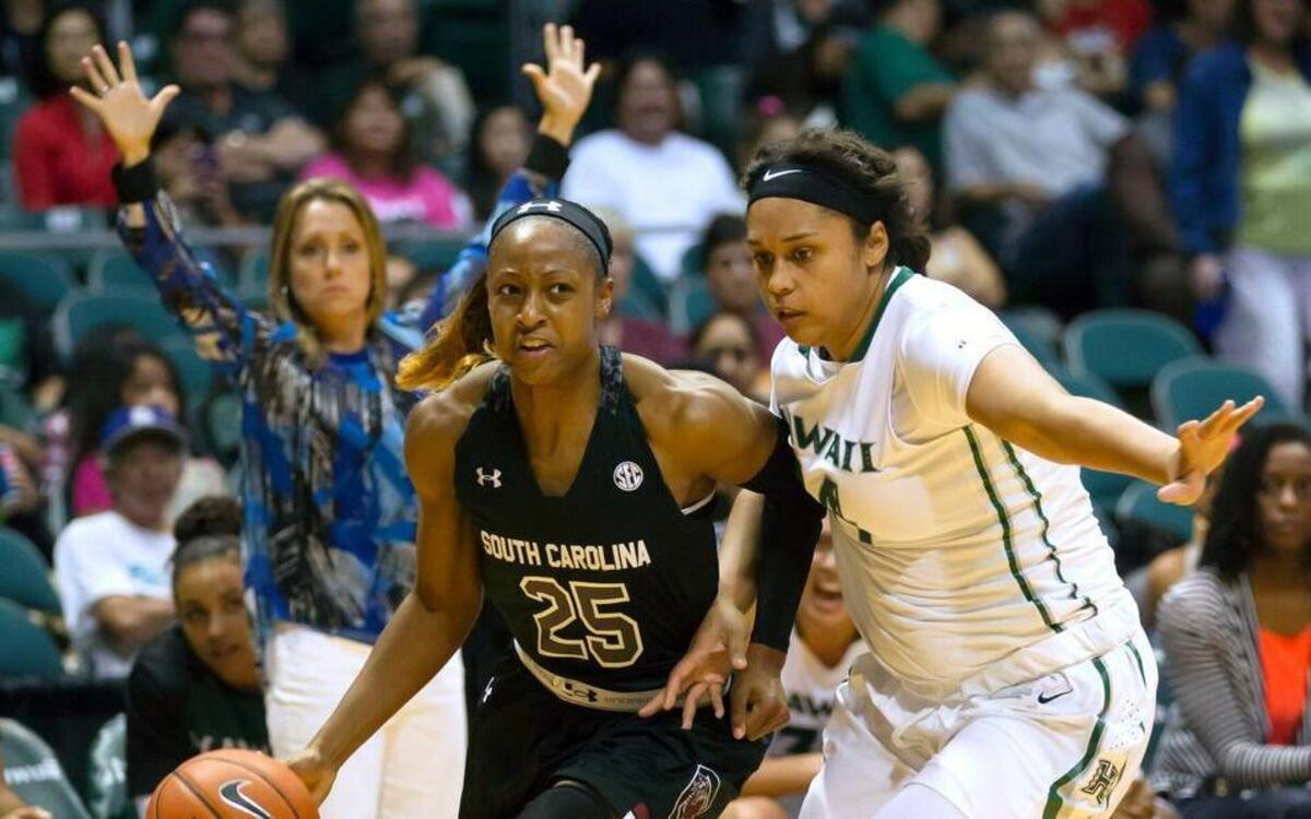Tiffany Mitchell drives as Hawaii guard Destiny King defends on Sunday.