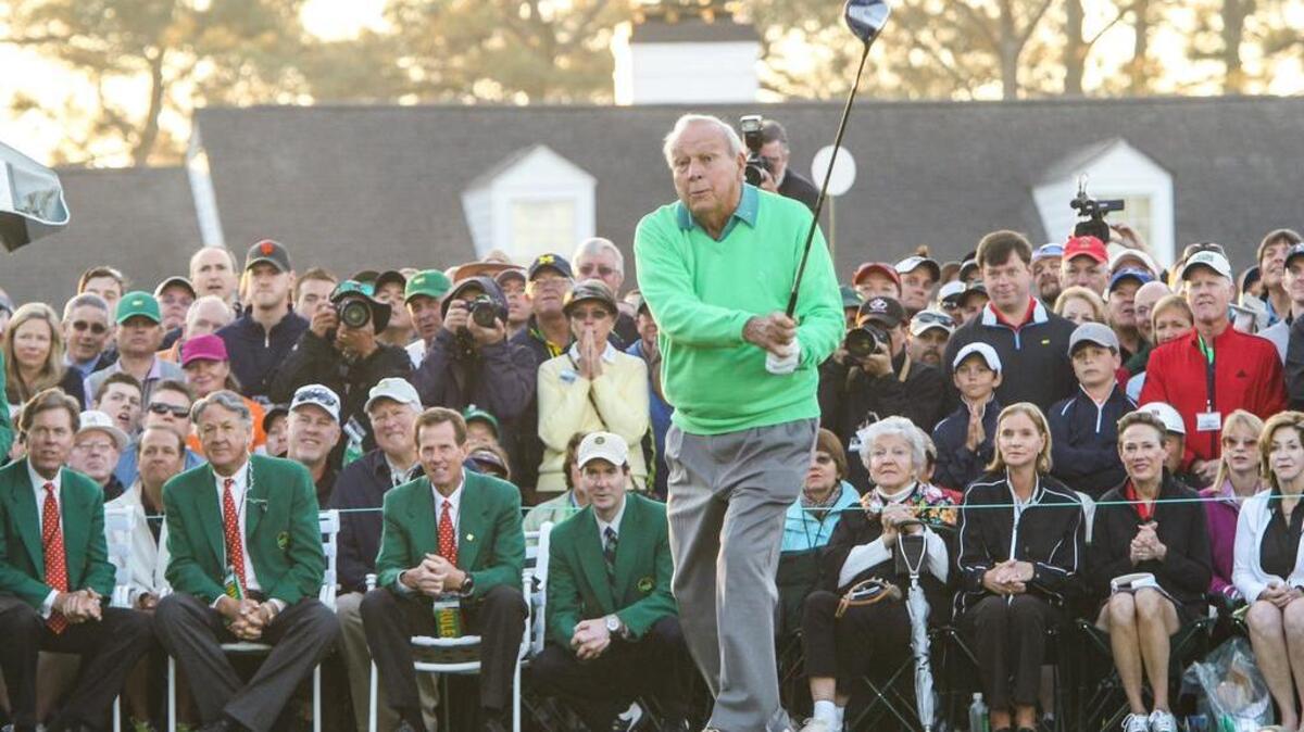Arnold Palmer tees off on the first hole to begin the first round of the Masters in 2014.