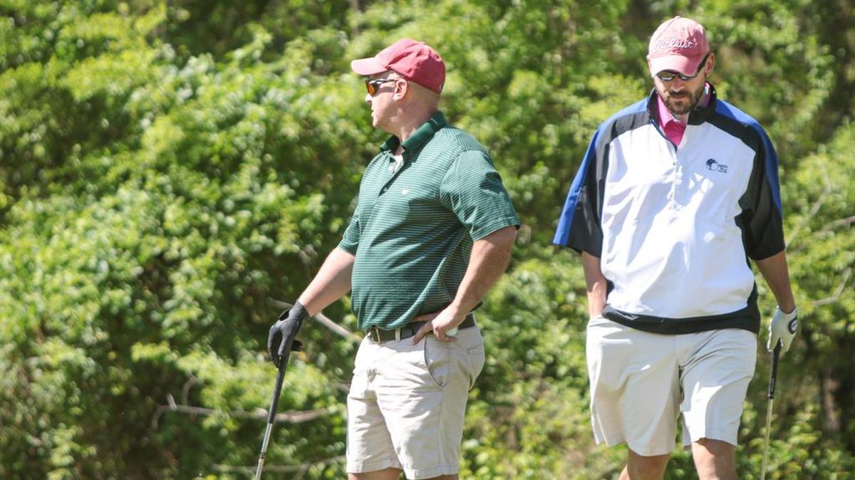 Rich Sutherland, left, and Jason Krug of Boston, Mass., golf with a group of friends at The Country Club of Lexington.