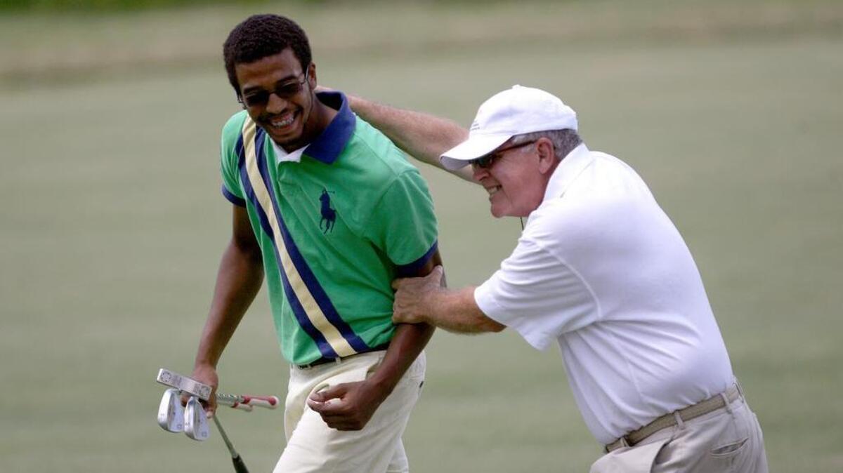 In this file photo, Bobby Foster congratulates Will Godfrey on his win in the Midlands Chevy Dealers City Tournament at The Members Club's Woodcreek Course in 2011.
