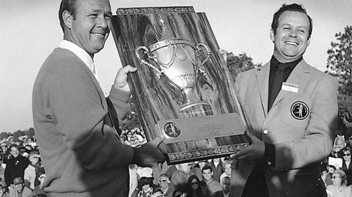 Arnold Palmer, left, is presented a plaque after winning the first Heritage golf tournament. The event’s founder, Sea Pines developer Charles Fraser, makes the presentation.