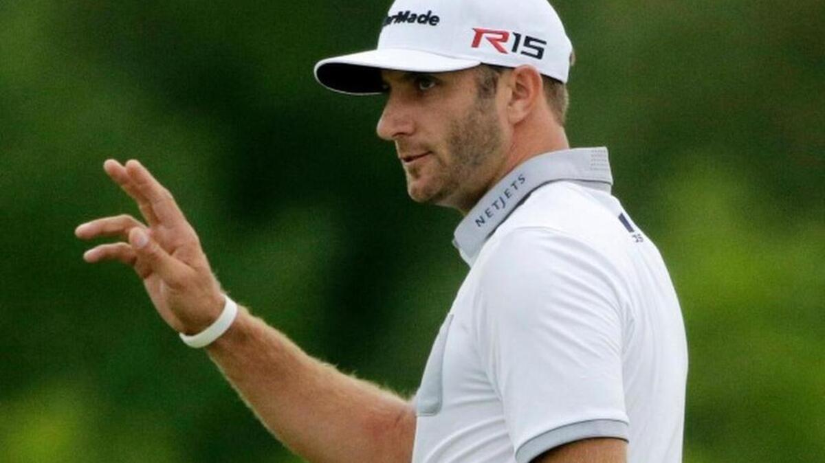 
Dustin Johnson waves after making a birdie putt on the 10th hole during the first round of the PGA Championship golf tournament Thursday, Aug. 13, 2015, at Whistling Straits in Haven, Wis.
