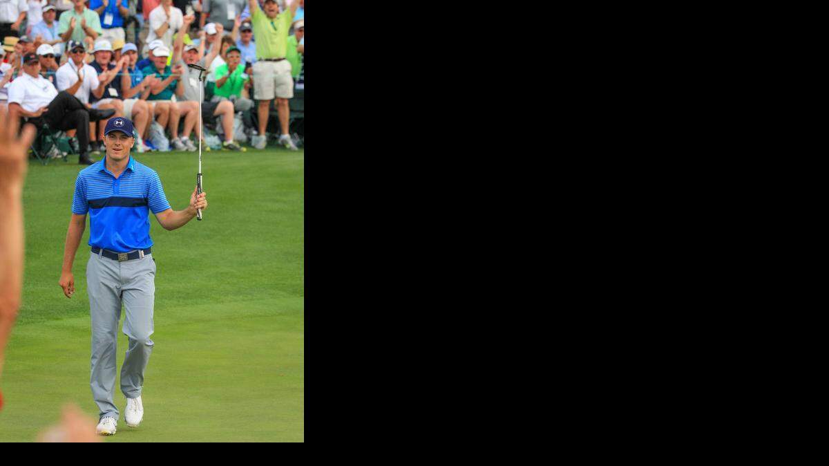
Jordan Spieth celebrates a birdie on the 18th green to go 8 under par and take the lead going into the second round of the 2015 Masters golf tournament, Thursday. 

