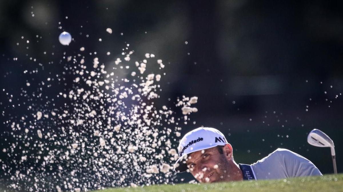 Dustin Johnson hits from a bunker on the par-4 17th hole during the third round of the Masters at Augusta National.
