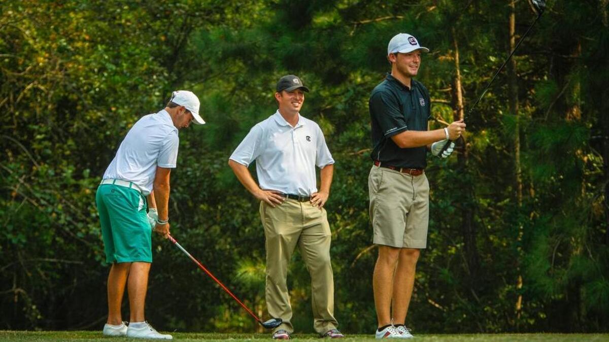 
USC golfer Matt NeSmith, right, practices as assistant coach Alex Hamilton watches. 
