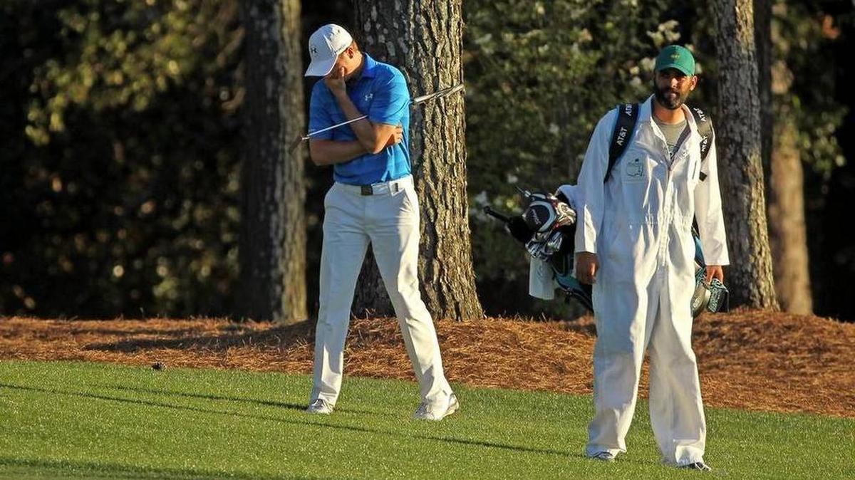 Jordan Spieth stands dejected alongside caddie Michael Greller on the 18th fairway during final round of The Masters at Augusta National Golf Club in Augusta.