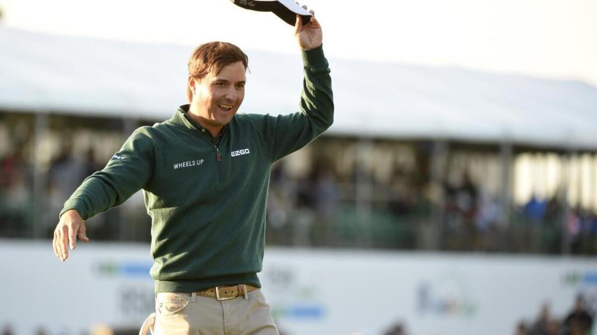 Kevin Kisner (Aiken) waves after sinking his putt on the 18th green to win the RSM Classic, his first PGA Tour victory.